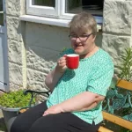 Disable woman takes a break from gardening with Enterprise Club