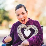 Lady with Palsy holding a gift